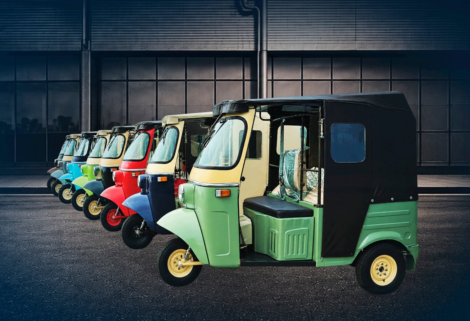 A row of Sazgar three-wheelers in different colours at the factory